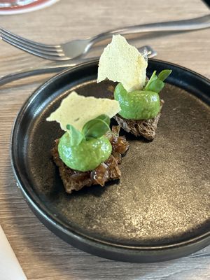 Amuse: toast with caramelized onions, pea mash and a potato ‘sheet'  at Brasserie Westerkade in Goes