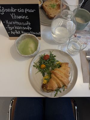 croissant filled with vegan scrambled egg and matcha latte  at Bistro Deppat in Vienna