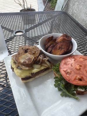 Deluxe burger.. and plantains. Party time. Excellent  at Kale Cafe Vegan Kitchen in Daytona Beach