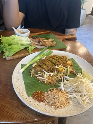 Top: pork pieces, bottom: pad thai with northern thailand banana leaf sausage  at Kem-Kon KhaoSan (เข้ม-ข้น ข้าวสาร) in Bangkok