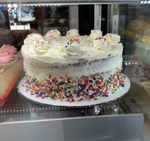 Incredible vanilla/funfetti birthday cake loaded with sprinkles! Available to purchase by the slice. 🎂  at Rainbow Bakery in Bloomington