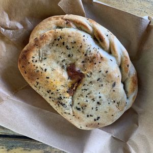 Pizza hand pie!! Amazing. at Rainbow Bakery in Bloomington