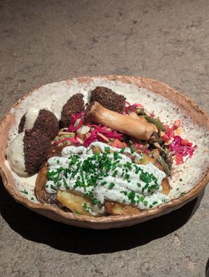 Miso bowl with falafel and truffle potatoes at Honest Greens in Valencia