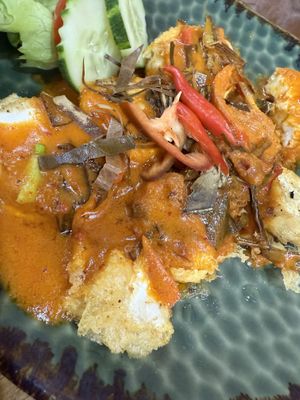 Closeup of soft tofu with curry sauce   at Begin Vegan Food in Chiang Mai