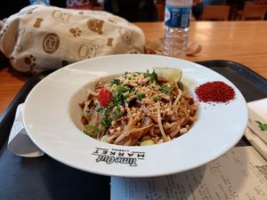 Pad thai with chilli powder and peanuts for toppings.

Ingredients: spring onion, mushroom, cherry tomato, courgette, etc at Asian Lab in Lisbon