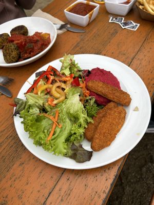Vegan Nuggets with red hummus and salad. Vegan Quinoa Fritters with Ratatouille    at Biergarten Waldheim in Munich