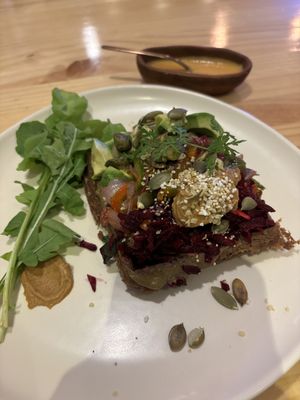 Savory waffle with veggies, seeds, and a delicious spicy sauce   at Kuruba in Cuenca