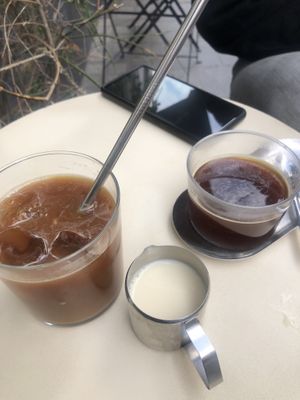 Iced decaf americano with oat milk and regular americano   at BOUCHE Specialty Coffee in Brussels