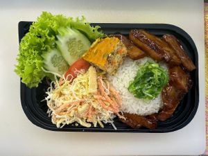 Cơm tấm chay (vegan broken rice): rice, vegan cutlet, vegan skins, vegan steamed meatloaf, salad and vegan fish sauce at Chay Yêu Thương in Nha Trang