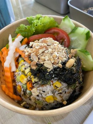 Cơm trộn rong biển (seaweed tossed rice): white rice tossed with sweet corn, peas, carrots, lotus seed, lotus& mushroom mocked meatloaf, mushroom floss, toasted nuts and seawe at Chay Yêu Thương in Nha Trang