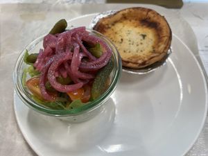 Mushroom pie served with side salad (with pickled cabbage and pickles with a vinaigrette sauce).   at AMS - Salon Deli in Amsterdam
