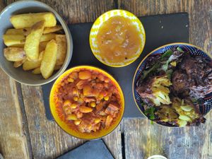 Chips, tagine, mango chutney and onion bhaji at Hop In Beer & Gin in Brecon