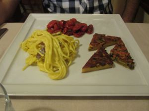 Spaghetti alla carbonara: farinata made with chickpea flour, zucchini; and roasted tomatoes. This is the 'large' plate of the day for 10 euros. A smaller amount is available for 8 euros. at La Lanterna in Verona