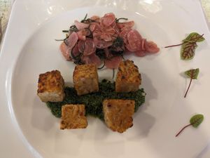 CHICKPEA TEMPEH SQUARES ON GREEN SAUCE WITH AGRETTI AND RADISHES WITH GARAM MASALA at La Lanterna in Verona