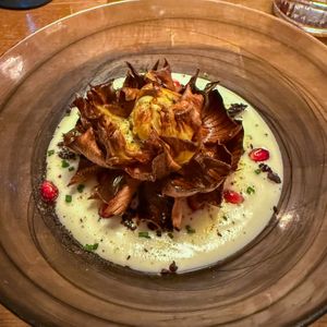 Crispy artichoke flower on cauliflower puree with pomegranate, olive powder and liquorice  at Bistro Esencia in Mallorca