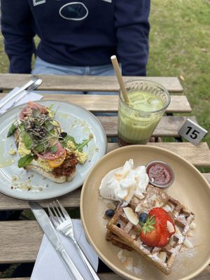 Scrambled tofu toast, Belgian waffles with compote and almonds and strawberry matcha iced latte.  at VERDE in Malmo