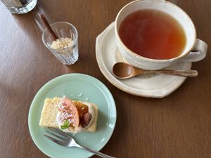 Dessert set- Black tea with brown sugar, rice flour almond cake with tofu cream, blood orange sauce, toasted almondd  at à petits pas in Sapporo