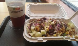 Iced ginger chai tea (heavenly) and a brown rice bowl with about ten things on top at Tikkaway Grill in New Haven
