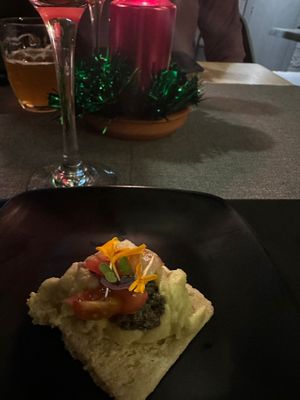 Purée artichoke with olive tapenade, caramelized onion, cherry tomatoes on a cracker.  at MEZZE in Granada