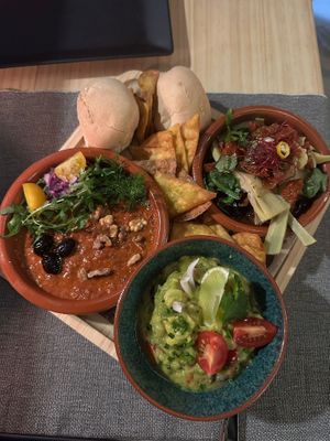 Mezze of mujadara with Moroccan olives, artichoke in oil with sun dried tomatoes, onion pickled in balsamic vinegar, and Italian olives, and guacamole with tequila.  at MEZZE in Granada