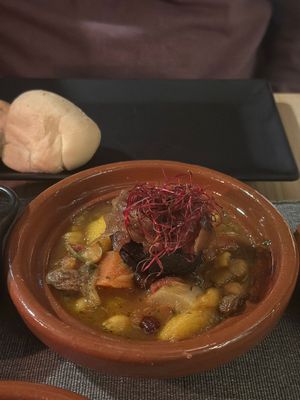 Morrocan tajine. Black bean spiced with black sausage spice with chickpeas , onion, raisins, carrots and tomatoes  at MEZZE in Granada