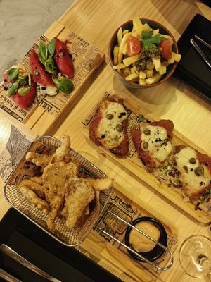 Stuffed bell peppers (left), chips with chimichurri (top), milanesas (middle) and KFC (bottom). at MEZZE in Granada