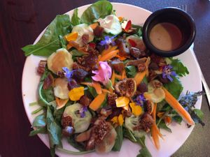 Garden greens salad with flowers and fig and dates at Sweet Potato Kitchen in Hawi