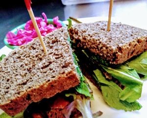 ELT Sandwich! The 'bacon' is made from seasoned eggplant. Delicious!! Served with a side of homemade pickles and red cabbage kraut. at Sweet Potato Kitchen in Hawi