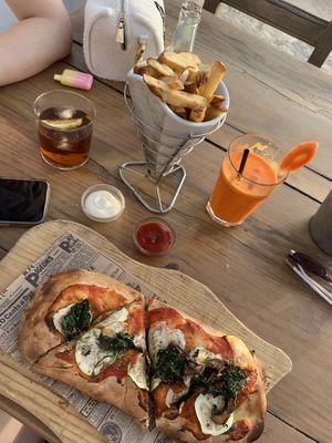 Vegan pizza and fries  at Golden Buddha in Ibiza