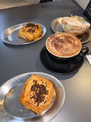 Ham and cheese pastry, hot chocolate, girello pistachio at the back right   at The Sanctuary - PBerg in Berlin
