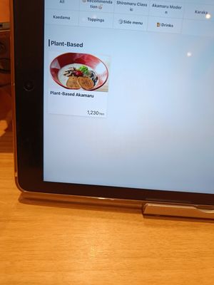 All the vegan options are neatly listed on the tablet at IPPUDO Ginza East in Tokyo