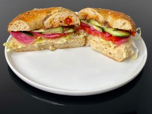 Mediterranean sandwich (minus feta) on a rosemary sea salt bagel (plated at home) at Bloom Bistro & Grocery in Seattle