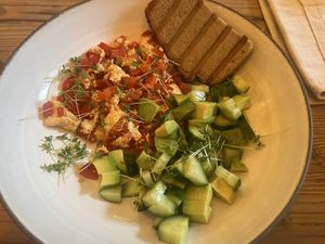 Tofu tomato scramble, diced avocado and cucumber salad with whole grain toast  at The Green Station in Almaty