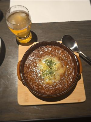 Grilled potatoes with soy meat keema and soy cheese, and a beer at Cafe & Bar Oku in Kyoto