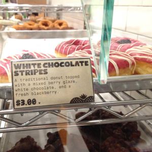 donut case: the 'V' next to the price = vegan at Donut Friend - Highland Park in Los Angeles