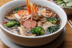 Vegan Rad Na Noodles - Wide rice noodles or crispy egg noodles with a hearty stew of sesame soy sauce with Chinese rice wine, Chinese broccoli and/or broccoli, fermented soybean, carrot, and button mushrooms. at Sukho Thai - Marigny in New Orleans