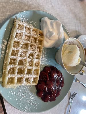 Waffle with vanilla ice cream, whipped cream and cherries   at Cafe Hibiskus in Cologne