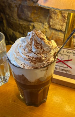 Dark hot chocolate with vegan cream  at Cafe Rotkehlchen - Venloer Str in Cologne