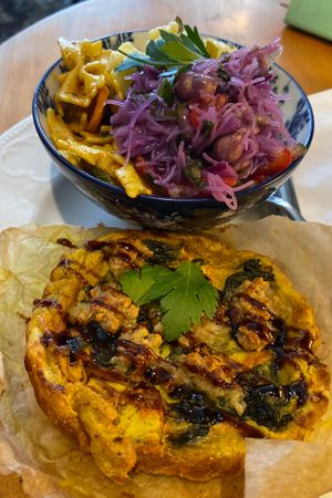 Quiche with carrot 'salmon' and two salads- pasta and potato.  at Cafe Rotkehlchen - Venloer Str in Cologne