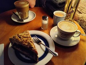 Peanut cake and a cappuccino with oatmilk at Cafe Rotkehlchen - Venloer Str in Cologne
