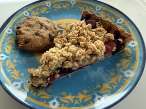 Apple crumble with red berries and a cookie   at Canela in Bruges