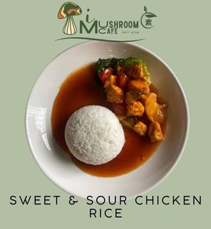 Sweet and Sour Chicken Rice is a vegetarian dish made with plant-based chicken, coated in a tangy, sweet sauce, served with rice. at i Mushroom Cafe in Kota Kinabalu