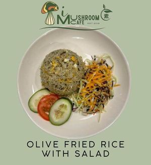 Olive Fried Rice with Salad is a savory vegetarian dish featuring fried rice with olives, complemented by a fresh, crisp salad. at i Mushroom Cafe in Kota Kinabalu