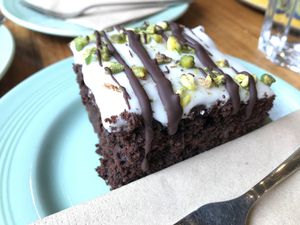 Posh Brownie with pistachio and white choc - The consistence was more like a cake not as fudgy as you expect a brownie to be, but taste was okay in general. at Eden Cafe in Witney