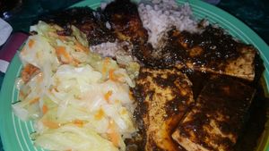 Jerk tofu with rice n beans and cabbage.  Fully vegan.  Spicy spicy spicy but packed with flavor.   at Reggae Shack Cafe in Gainesville