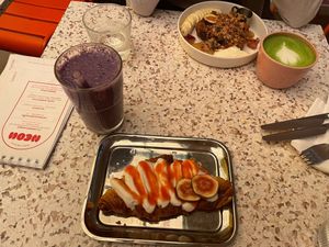 Smashed croissant with coconut cream and strawberry purée and blueberry shake at neon in Muenster