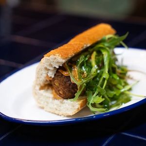 Lentil "octopus" meatballs sandwich, with spicy pumpkin-chipotle sauce, and arugula at Doxa in Madrid