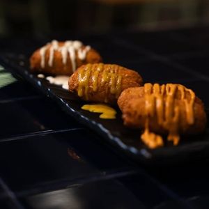 Falafels with pumpkin-chipotle sauce, agave-mustard, and pickle mayonnaise at Doxa in Madrid