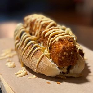 Tofu Sando: rustic brioche bread, coleslaw, super crispy tofu, and sauces at Doxa in Madrid