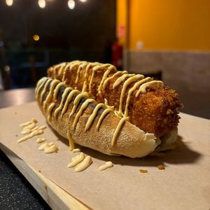 Tofu Sando: rustic brioche bread, coleslaw, super crispy tofu, and sauces at Doxa in Madrid